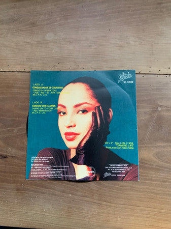 Sade : Conquistador De Corazones = Smooth Operator / Cuidado Con El Amor = Hang On To Your Love (7", Single)