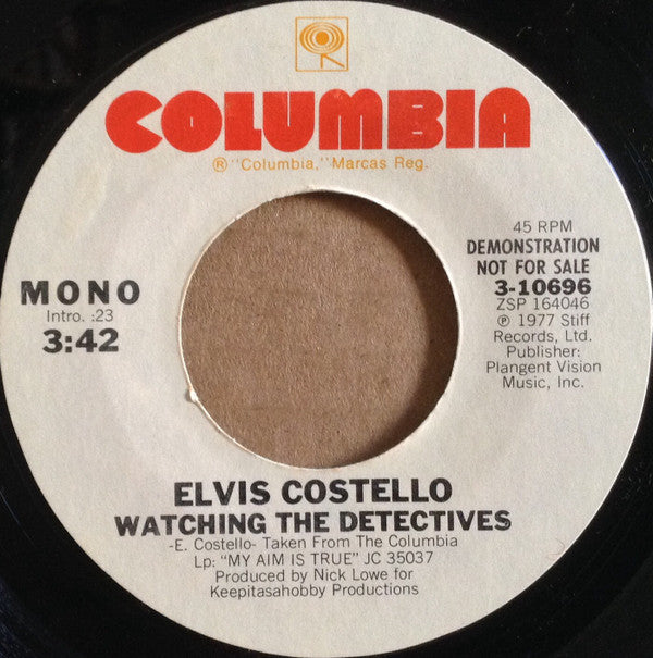 Elvis Costello : Watching The Detectives (7", Single, Mono, Promo, Styrene, Ter)